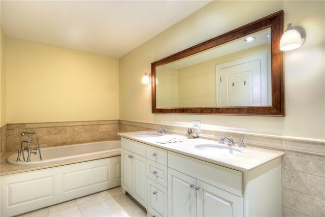 bathroom featuring vanity, a tub to relax in, and tile patterned floors