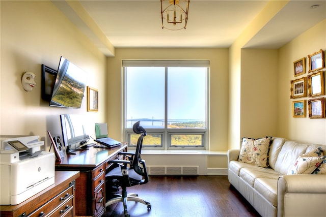 office area with a wealth of natural light, dark hardwood / wood-style floors, and a notable chandelier