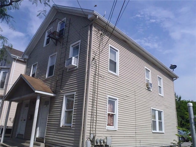 view of side of home featuring cooling unit