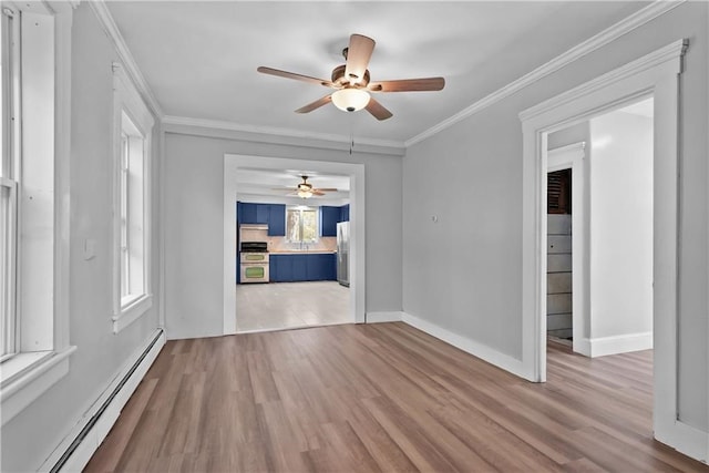 empty room featuring a baseboard heating unit, ceiling fan, hardwood / wood-style flooring, and crown molding