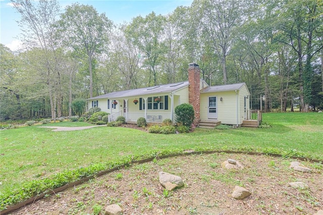 ranch-style home with covered porch and a front lawn