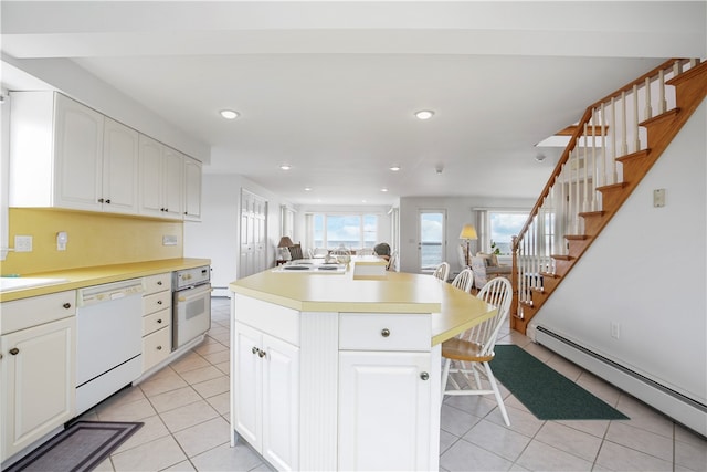 kitchen with a baseboard radiator, white appliances, white cabinetry, and a kitchen island