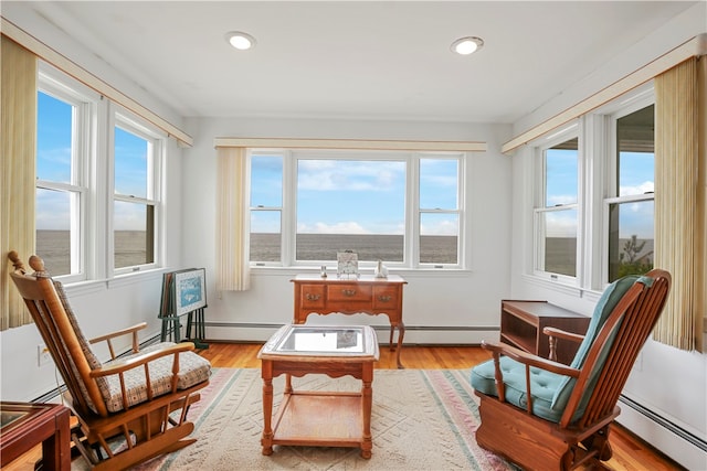 sunroom / solarium with a baseboard heating unit