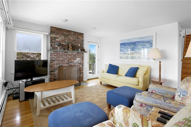 living room featuring light wood-type flooring and a fireplace