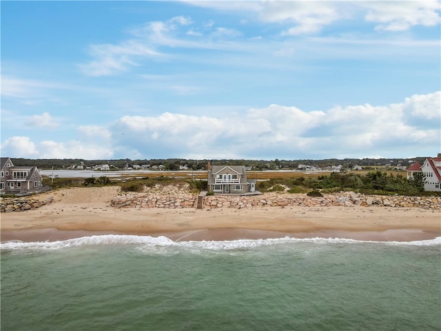 drone / aerial view featuring a view of the beach and a water view