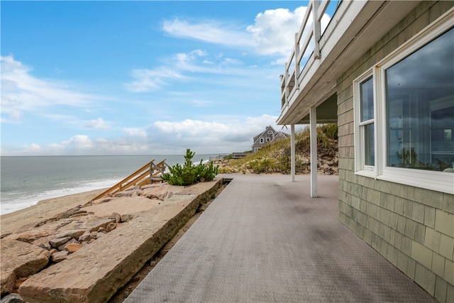 exterior space featuring a view of the beach and a water view