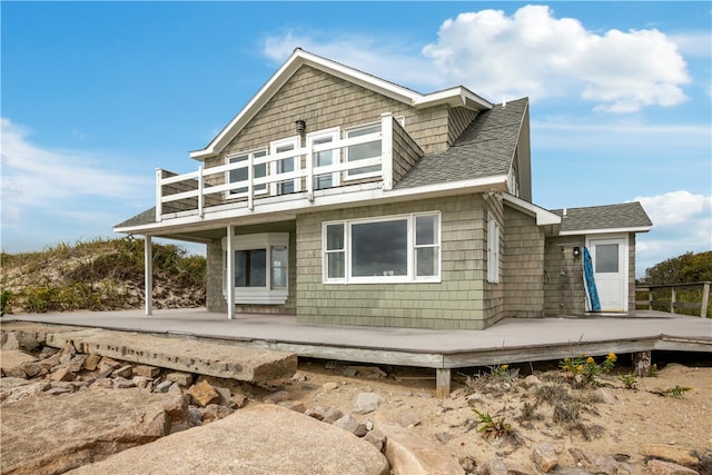 back of house featuring a wooden deck