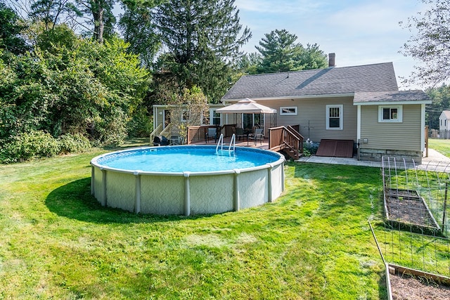 view of pool with a lawn and a deck