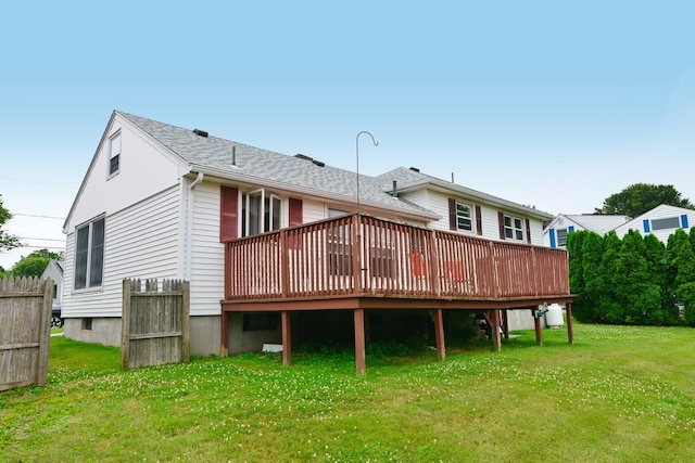 rear view of house with a yard and a deck