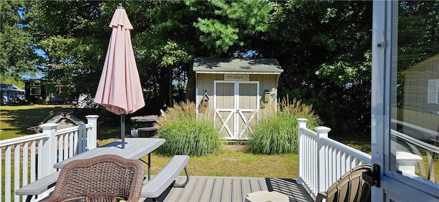 wooden deck featuring a shed and a yard