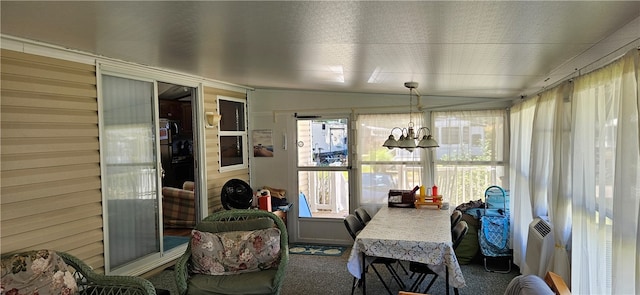 sunroom featuring a notable chandelier