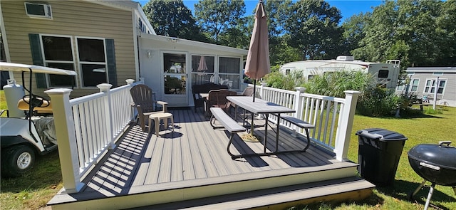 wooden terrace with area for grilling and a yard