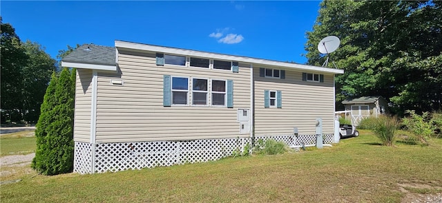 view of property exterior featuring a storage shed and a yard