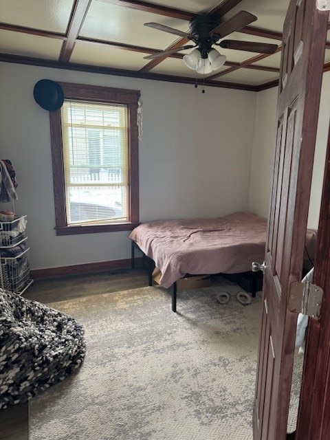 bedroom featuring ornamental molding, coffered ceiling, hardwood / wood-style floors, and ceiling fan