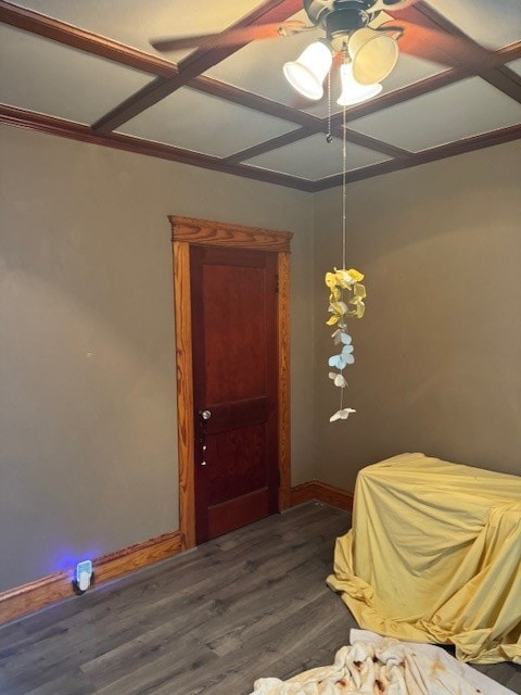 unfurnished bedroom featuring ceiling fan, ornamental molding, dark hardwood / wood-style flooring, and coffered ceiling