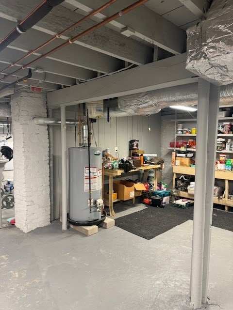 basement featuring water heater and a workshop area