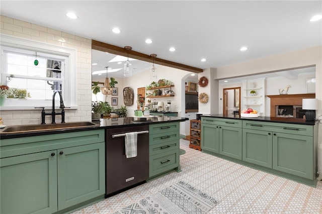 kitchen featuring green cabinetry, dishwasher, beamed ceiling, and sink