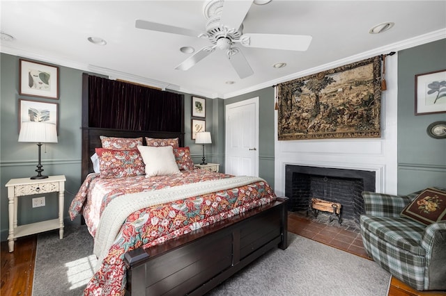 bedroom with ornamental molding, ceiling fan, and hardwood / wood-style flooring