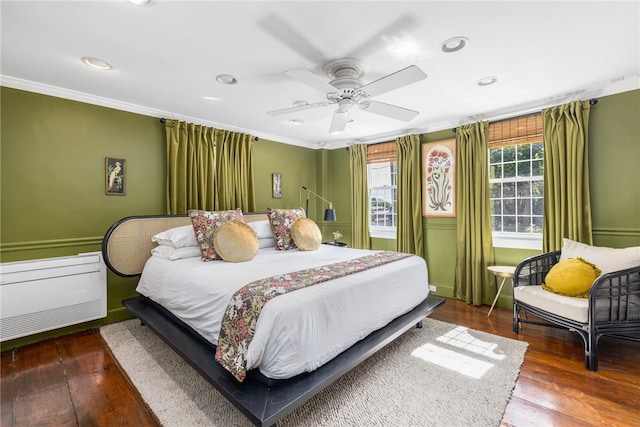 bedroom with wood-type flooring, ceiling fan, and crown molding