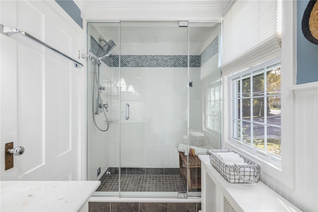 bathroom featuring a shower with door