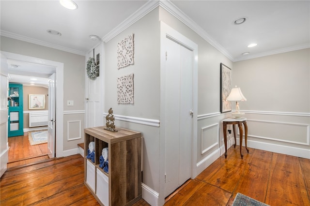 hall featuring wood-type flooring and crown molding