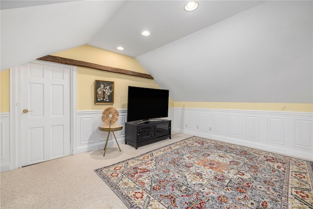 interior space featuring carpet floors and vaulted ceiling