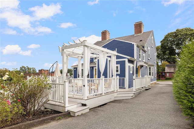 exterior space featuring a pergola and a deck