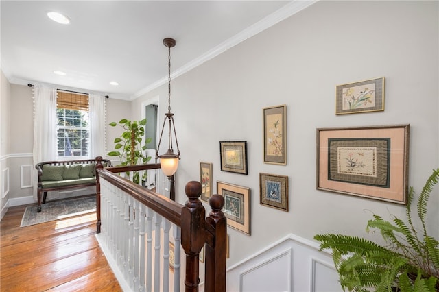 hallway featuring wood-type flooring and crown molding