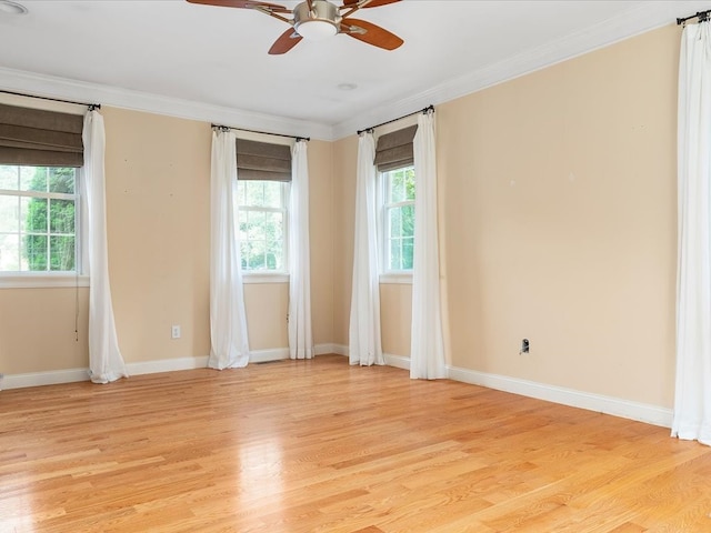 empty room featuring ceiling fan, light wood-type flooring, and ornamental molding