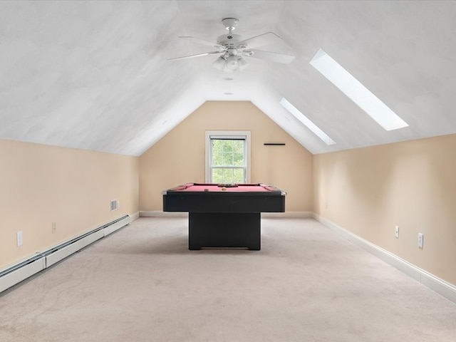 playroom with a baseboard radiator, ceiling fan, light colored carpet, and lofted ceiling with skylight