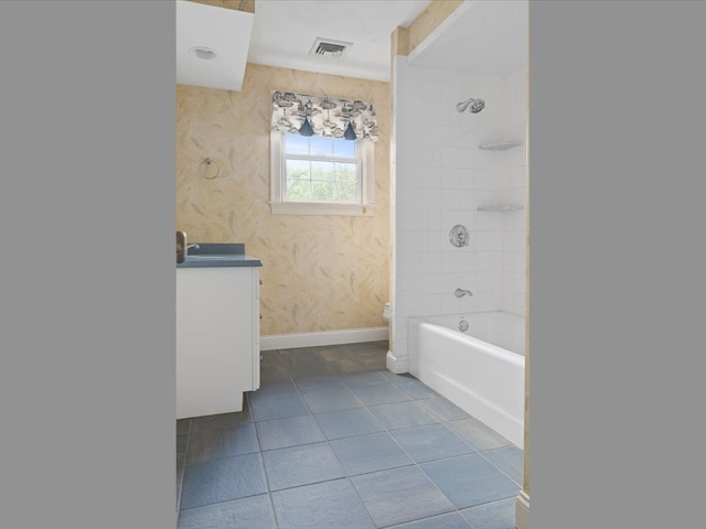 full bathroom with vanity, tiled shower / bath combo, toilet, and tile patterned flooring