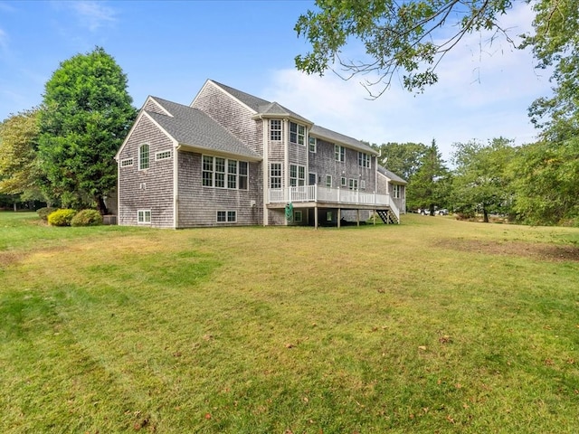 back of house with a wooden deck and a lawn