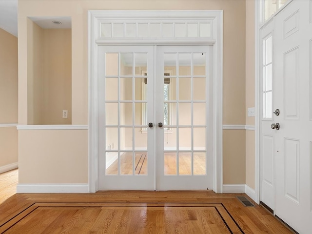 doorway to outside featuring french doors and hardwood / wood-style flooring