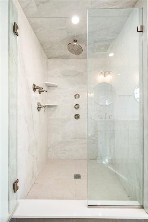 bathroom featuring a shower with door