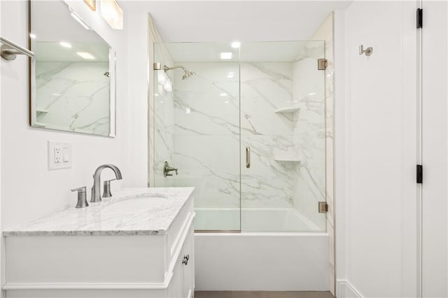 bathroom featuring vanity and enclosed tub / shower combo