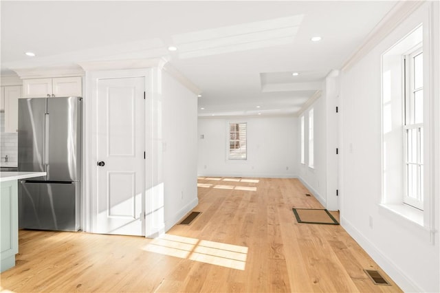 interior space with light hardwood / wood-style floors and ornamental molding