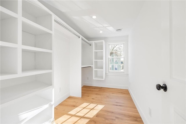 walk in closet featuring hardwood / wood-style flooring