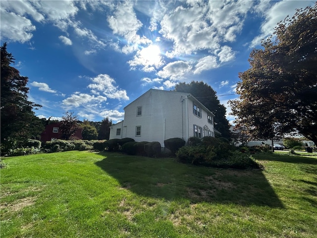 view of property exterior featuring a yard