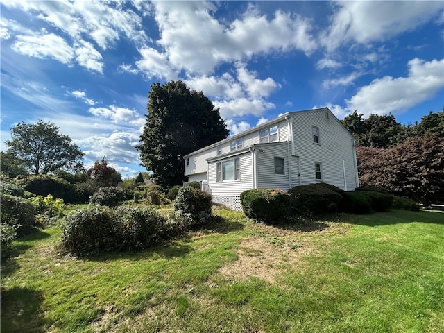 view of side of property featuring a yard