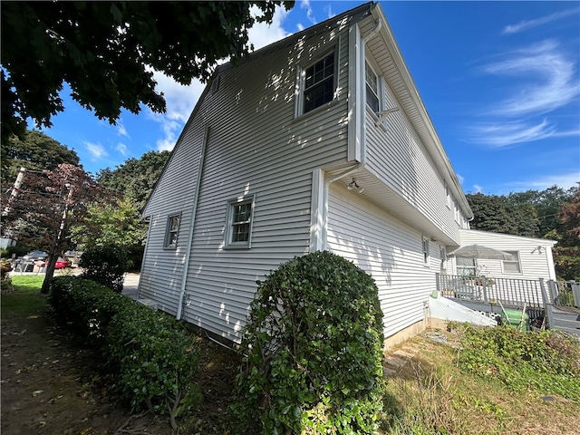 view of side of property featuring a wooden deck