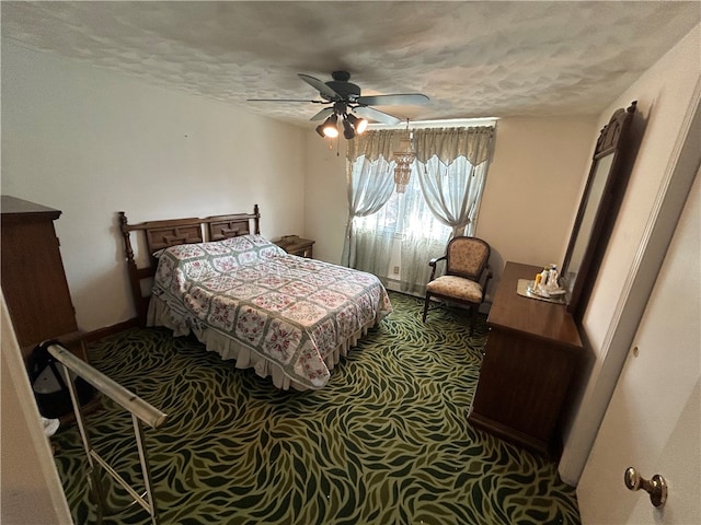 carpeted bedroom featuring a textured ceiling and ceiling fan