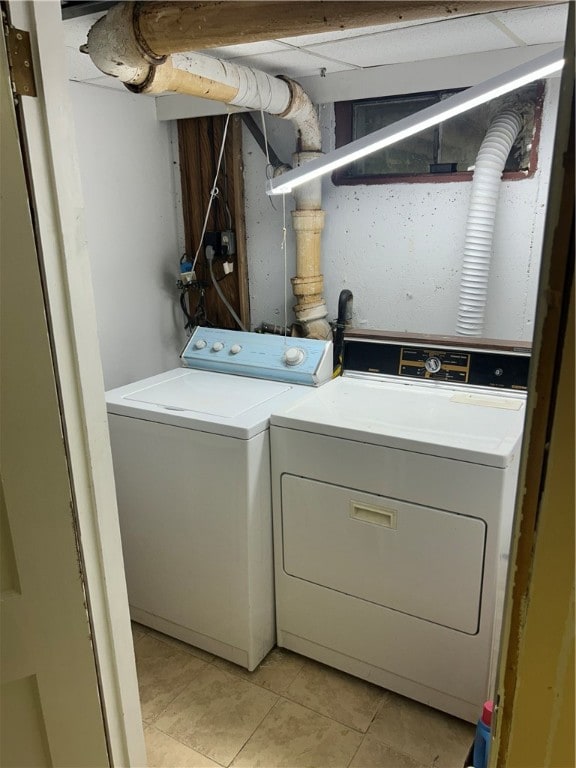 laundry area featuring independent washer and dryer and light tile patterned floors