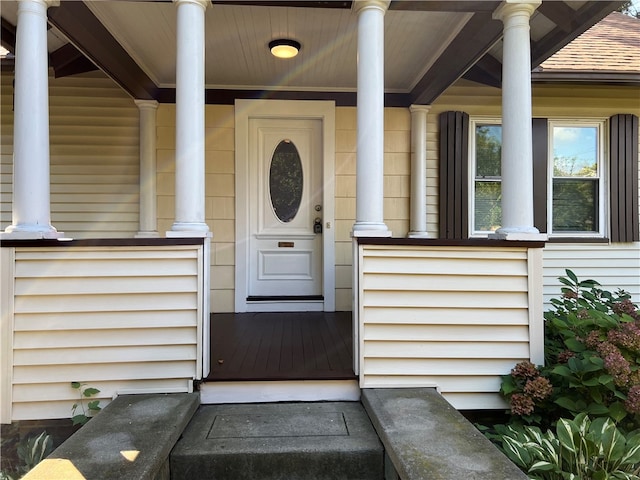 view of exterior entry with a porch