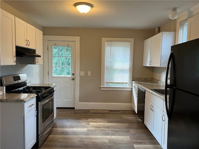 kitchen with white cabinets, dark stone counters, dark wood-type flooring, and black appliances