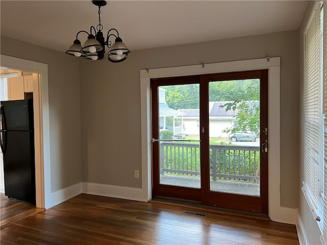 interior space featuring an inviting chandelier and dark hardwood / wood-style floors