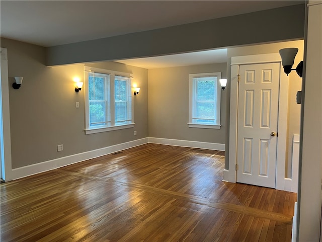 spare room with dark hardwood / wood-style floors