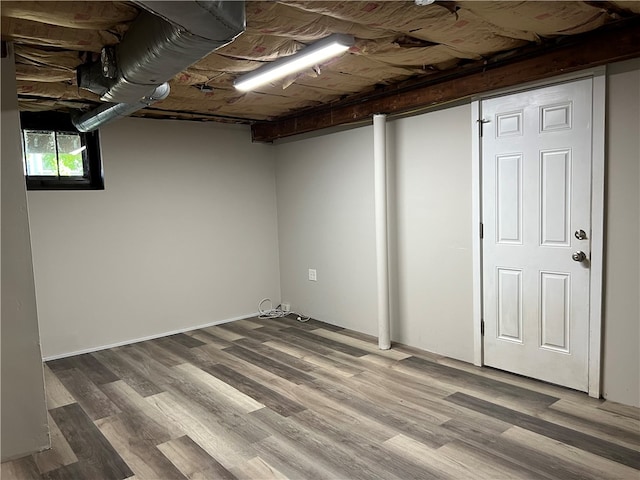 basement with hardwood / wood-style floors