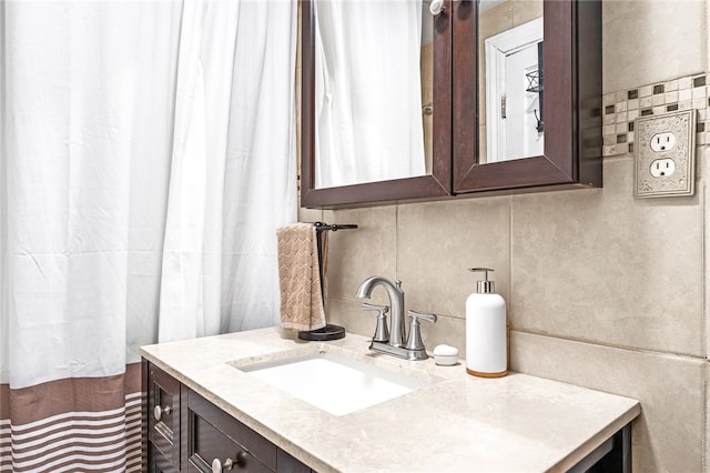 bathroom with vanity and tasteful backsplash