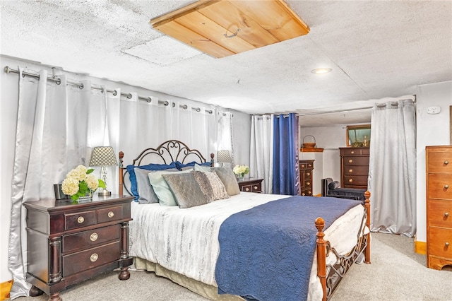 carpeted bedroom featuring a textured ceiling