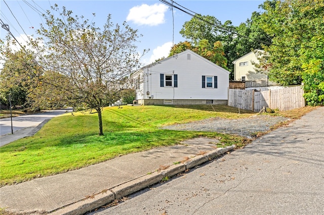 view of side of home featuring a lawn